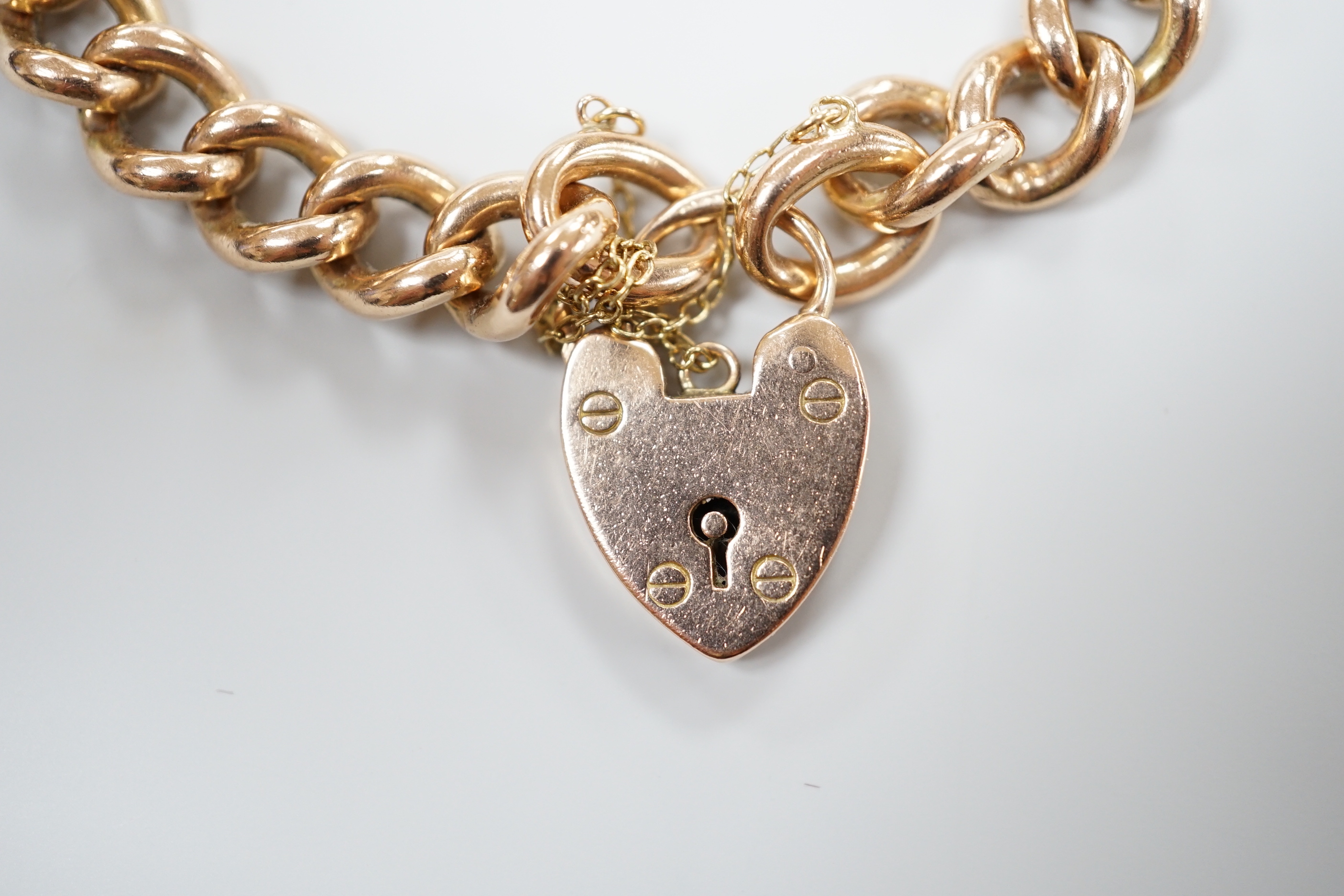 A 9ct gold curb link bracelet, with heart shaped padlock clasp, 18cm
